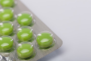 green medicin pills on white table
