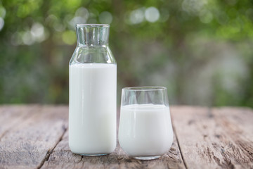 Milk bottle and milk glass on wooden table