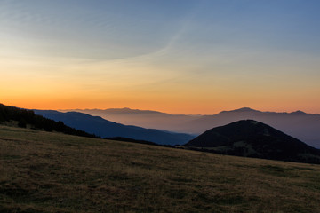 Sunrise from a valley watching the mountains with a little fog. Nature concept