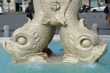 Fototapeta na wymiar Closeup of two dolphin heads of the Fontana del Tritone on the Piazza Barberini in Rome, Italy, Europe
