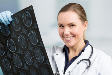 smiling doctor with an x-ray image