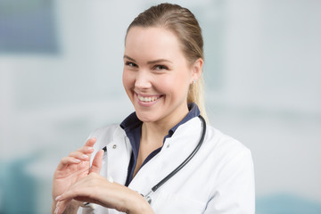 young female doctor is applying protective hand cream