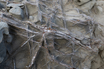 Natural volcanic stone texture. Rock texture with metal elements (Selective focus)
