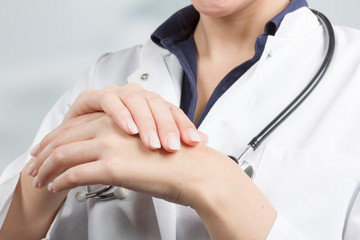 young female doctor is applying protective hand cream