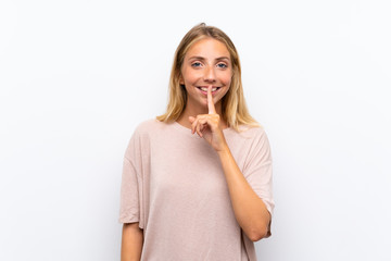 Blonde young woman over isolated white background doing silence gesture