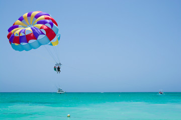 Colorful parasail wing flying over turquoise water of Sargasso Sea, Punta Cana, Dominican Republic