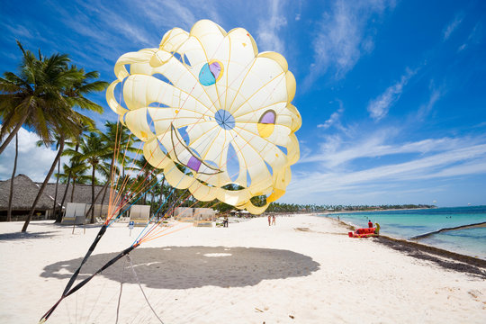 Colorful parasail wing over sandy beach of Sargasso Sea, Punta Cana, Dominican Republic