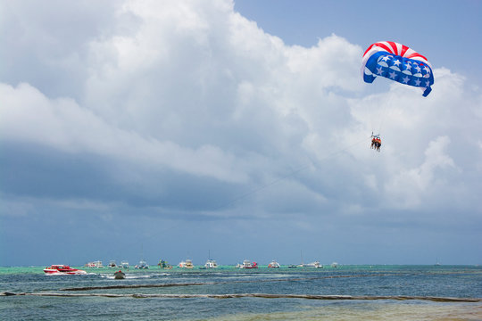 American flag colors parasail wing flying over turquoise water of Sargasso Sea, Punta Cana, Dominican Republic