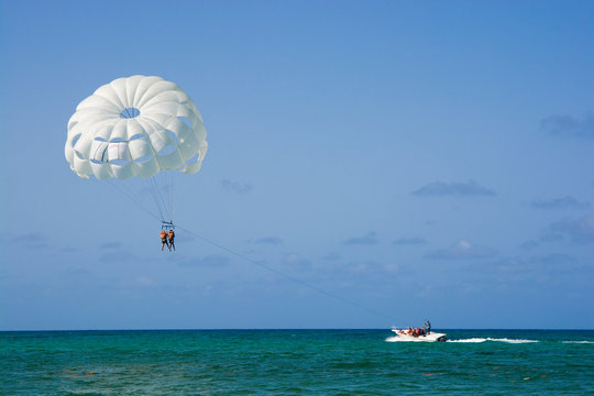 White parasail wing flying over turquoise water of Sargasso Sea, Punta Cana, Dominican Republic