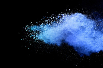 Blue sky color powder explosion on black background.