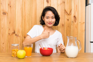 Asian young woman having breakfast milk giving a thumbs up gesture