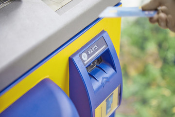 Close-up of an ATM system reading debit and credit bank cards. The concept of safe Backnock transactions, money transfers, cash withdrawals, payment for services and goods online.