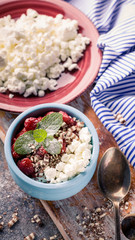 Cottage sweet dessert with Strawberry jam in blue deep bowl. Healty breakfast. Top view. Vertical shot