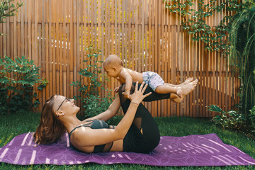 Mother doing baby yoga for her son