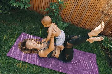 Mother doing baby yoga for her son