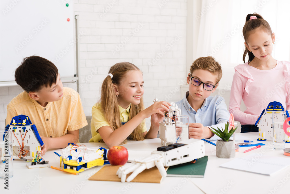 Poster Excited children creating robots together at stem class