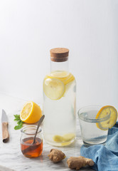 Ginger Water and its Ingredients, Such as Lemon and Honey, Vertical Orientation