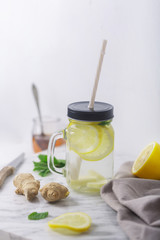Ginger Water in Glass jar With Lemon and Honey, Vertical Orientation, White Background