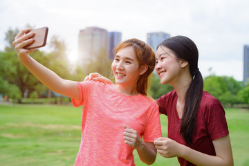 young asian woman jogging with selfie enjoyment