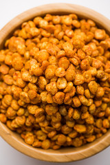 Fried and Spicy Chana Dal Masala is a popular Chakna recipe. served in a bowl. selective focus