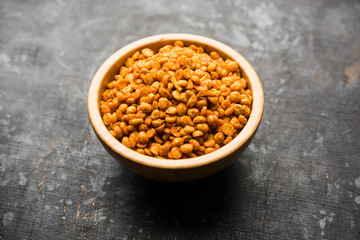 Fried and Spicy Chana Dal Masala is a popular Chakna recipe. served in a bowl. selective focus