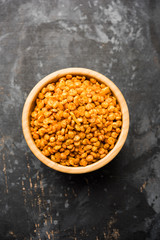 Fried and Spicy Chana Dal Masala is a popular Chakna recipe. served in a bowl. selective focus