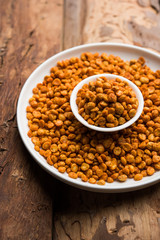 Fried and Spicy Chana Dal Masala is a popular Chakna recipe. served in a bowl. selective focus