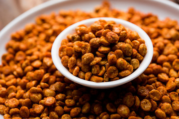 Fried and Spicy Chana Dal Masala is a popular Chakna recipe. served in a bowl. selective focus