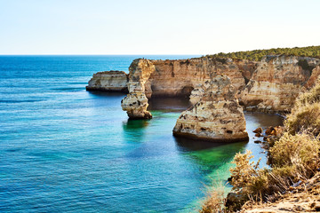 Fototapeta na wymiar Rocks and sandy beach in Portugal, Atlantic coast, Algarve.