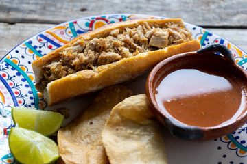 Mexican pork sandwich with red sauce also called 