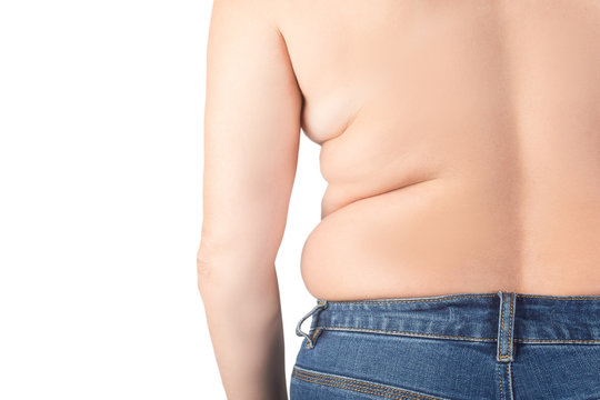 Problems of obesity and overweight, the image of a woman from the back in jeans.