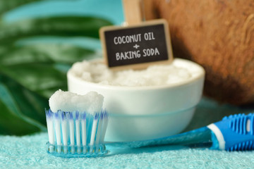 Coconut oil and baking soda in a bowl with a toothbrush - Homemade whitening toothpaste