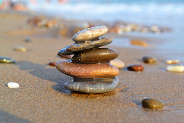 Little zen-style stone tower on the sandy beach