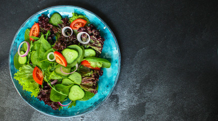 Healthy salad, leaves mix salad (micro green, cucumber, tomato, onion, other ingredients). food background. copy space
