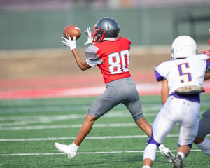 Great action photos of high school football players making amazing plays during a football game