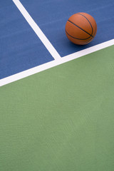 Basketball rests on court