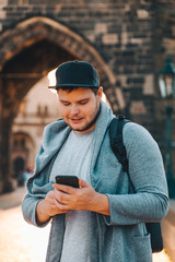 man in front of charles bridge in prague