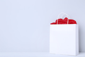 Paper shopping bag on grey background