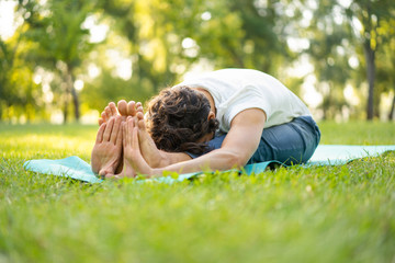 Man practicing  yoga in the park