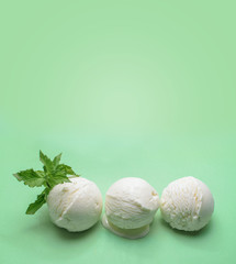 Balls of fresh ice cream with a sprig of mint.