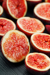 Ripe Figs. Creative diagram of chopped figs on a black textural background in the form of a texture inscribed in a rectangle