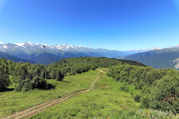Landscape views of the Caucasus Mountains, river and villages. Peak and river Enguri. Georgia. Summer. 2019