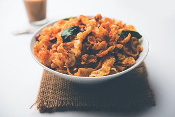 Cornflake Chivda or Corn Chiwda loaded with peanuts and Cashew. Served in a bowl. selective focus