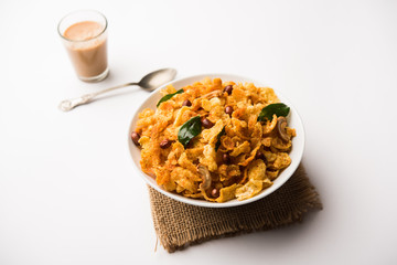 Cornflake Chivda or Corn Chiwda loaded with peanuts and Cashew. Served in a bowl. selective focus