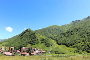 Landscape views of the Caucasus Mountains, river and villages. Peak and river Enguri. Georgia. Summer. 2019