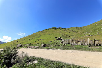 Landscape views of the Caucasus Mountains, river and villages. Peak and river Enguri. Georgia. Summer. 2019
