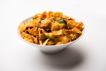 Cornflake Chivda or Corn Chiwda loaded with peanuts and Cashew. Served in a bowl. selective focus