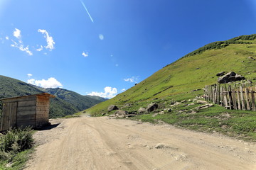 Landscape views of the Caucasus Mountains, river and villages. Peak and river Enguri. Georgia. Summer. 2019