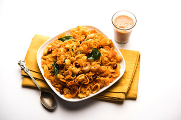 Cornflake Chivda or Corn Chiwda loaded with peanuts and Cashew. Served in a bowl. selective focus