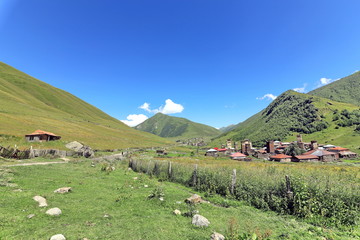 Landscape views of the Caucasus Mountains, river and villages. Peak and river Enguri. Georgia. Summer. 2019